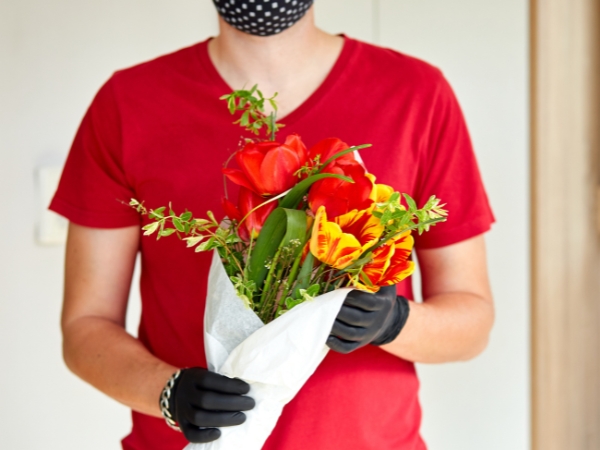 man holding a boquet at la rosa flower shop anniversary surprise
