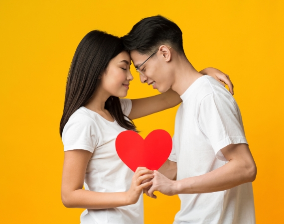 Couple cuddling holding a heart at La Rosa Flower Shop Romantic boquet