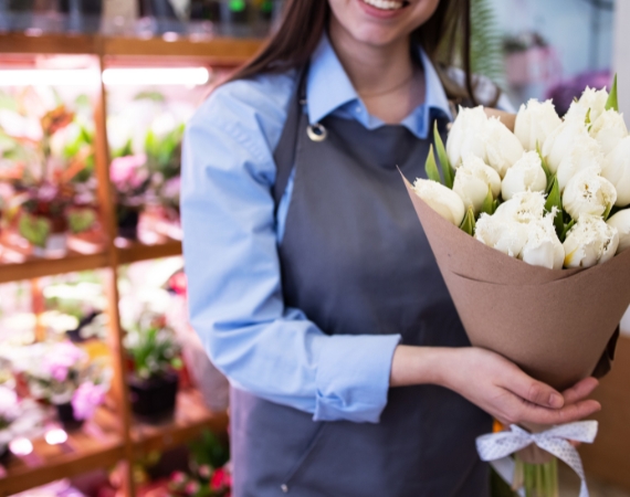 woman holding a boquet at La Rosa Flower Shop romantic boquet