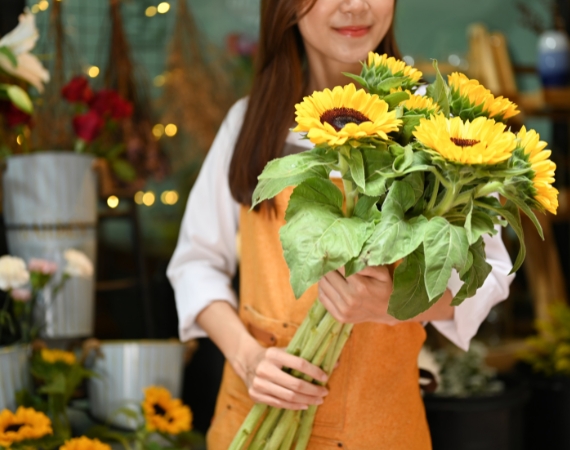 Woman holding a sun flower at La Rosa Flower Shop sunflower bouquet Metro Manila